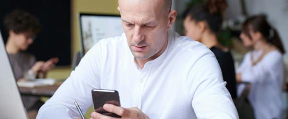 picture of man at desk on phone