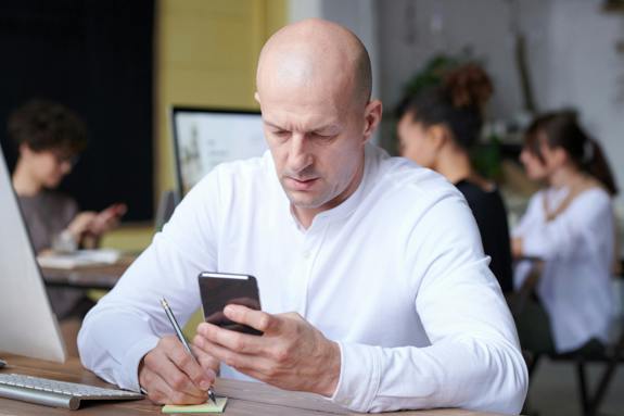 picture of man at desk on phone