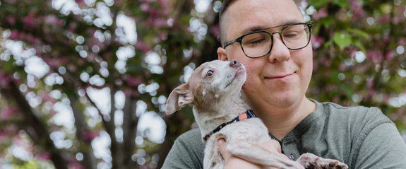 Man holding a small dog