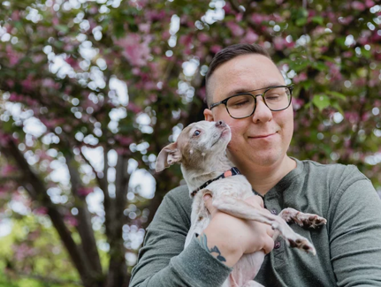 Man holding a small dog