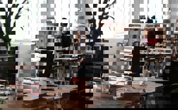 Office with one man sitting on desk