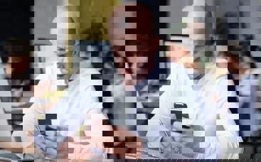 picture of man at desk on phone